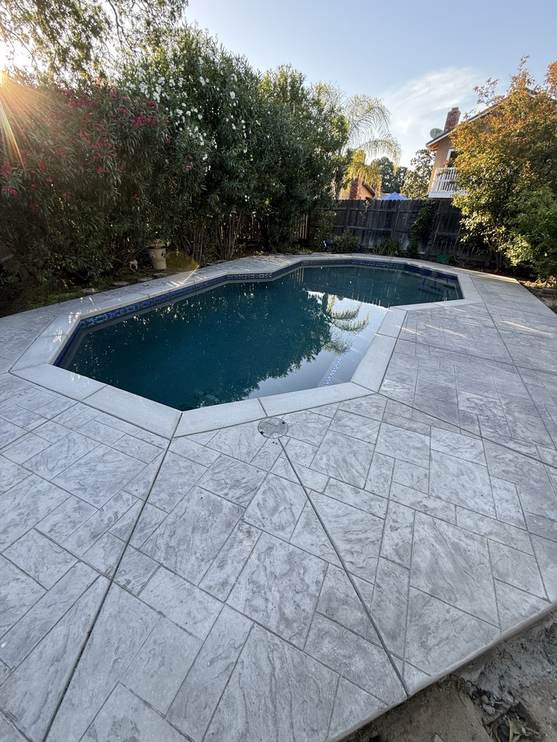 Same pool with new stamped marble decking and clear blue water