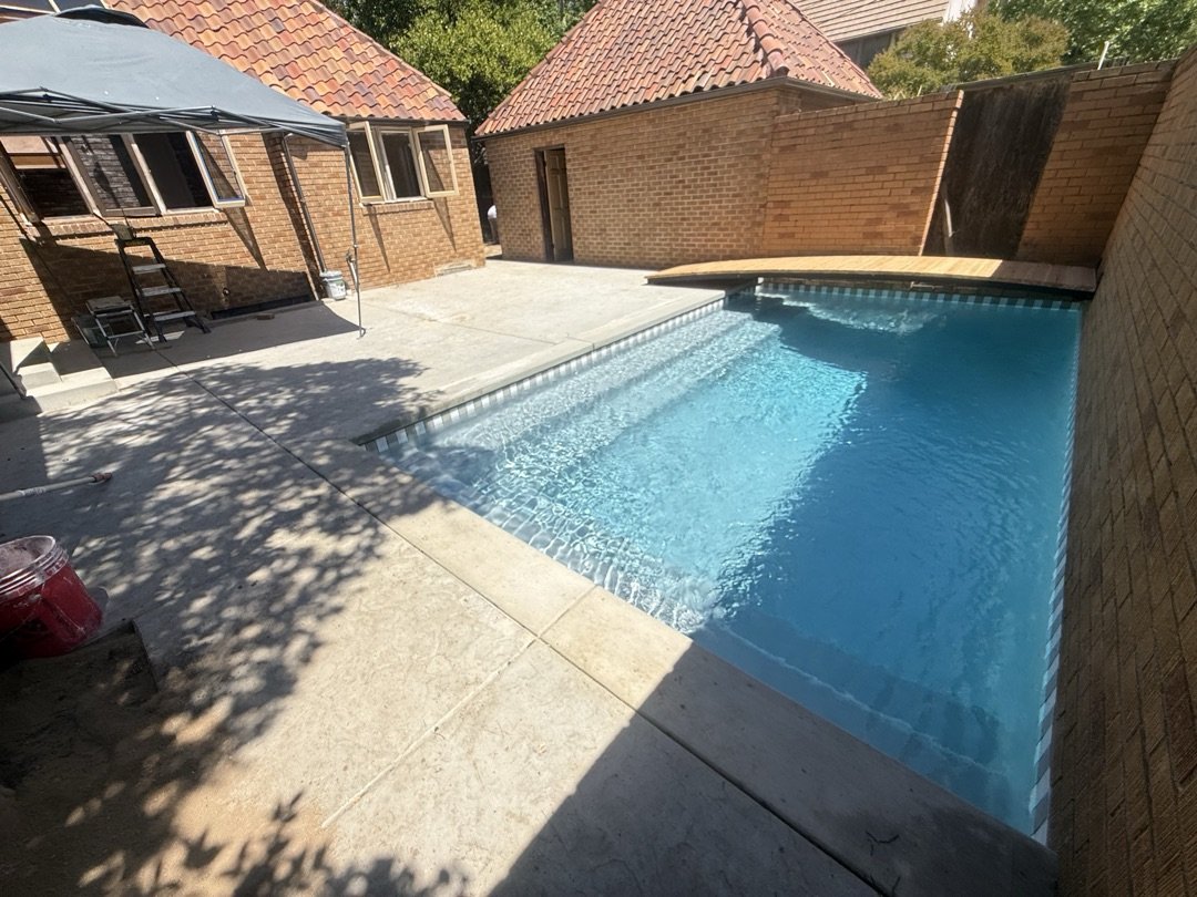 Finished pool with new plaster, tile, deck and fence in Sacramento Fab 40s neighborhood