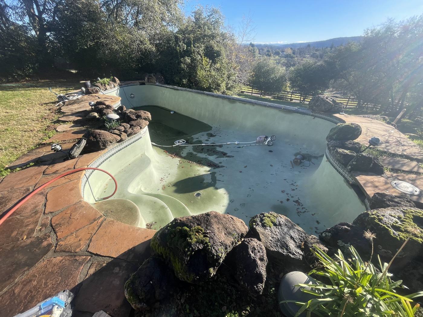 Pool before resurfacing and remodeling — aged and weathered