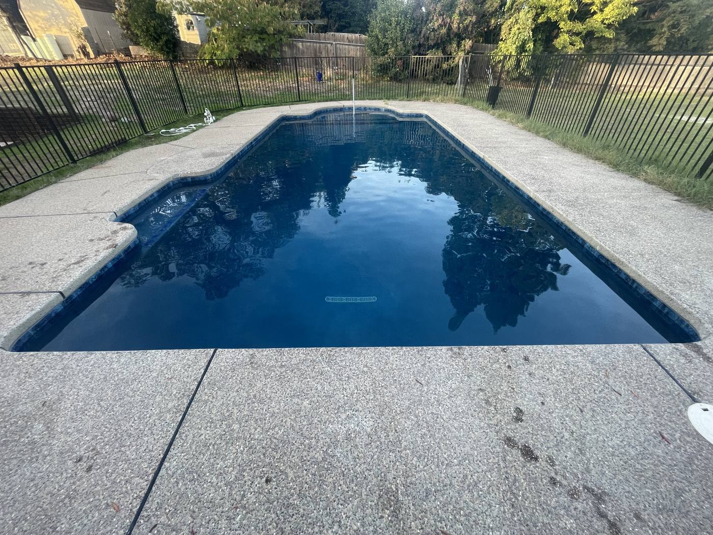 Backyard after outdoor living build — beautiful landscaping and patio